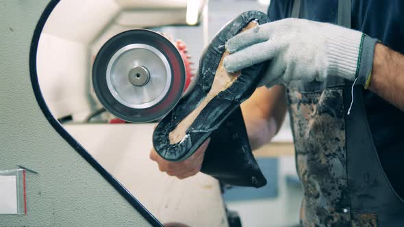 Leather Boot Is Getting Polished By a Plant Worker