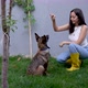 Girl Plays with a Cute Puppy in a Garden - VideoHive Item for Sale