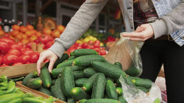 Young Attractive Woman Choosing Organic Vegatables at Farmer's Market Close Up Shot