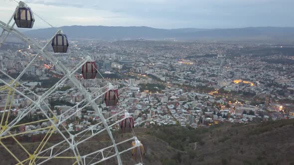 The Ferris wheel in Mtatsminda park. Against the background of the city. Tbilisi