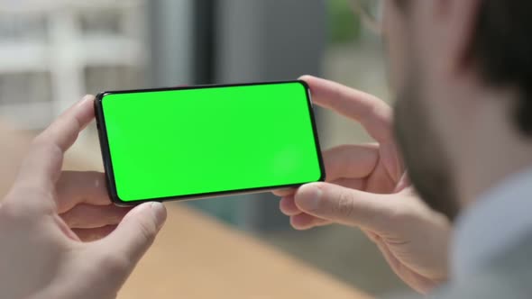 Close Up of Man Using Smartphone with Green Chroma Key Screen