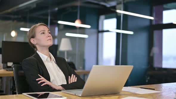 Serious Young Businesswoman Thinking in Office 