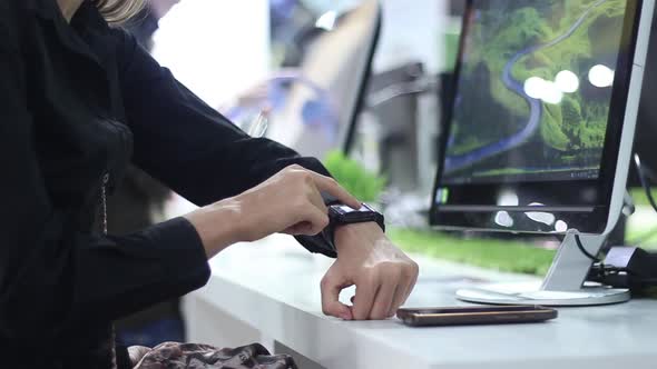 Woman Using Smart Watch In Modern Internet Cafe