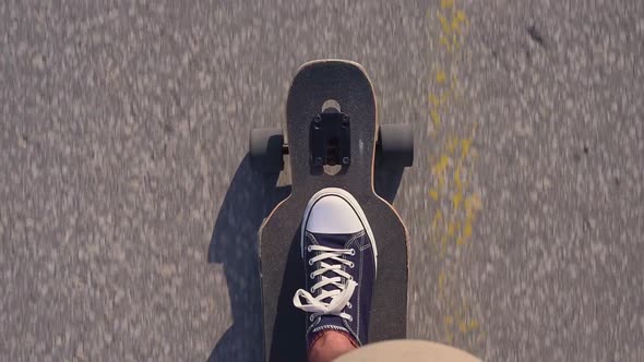 Riding Longboard Closeup Male Feet in Sneakers