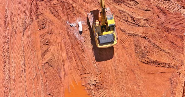 The Excavator Digs a Pit for the Connection of the Storm Sewer Pipes While Laying Underground Storm