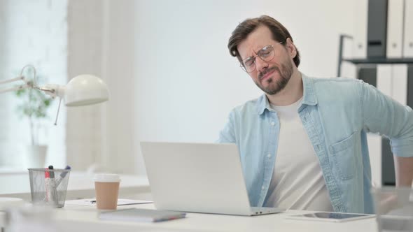 Young Man Back Pain Working Laptop