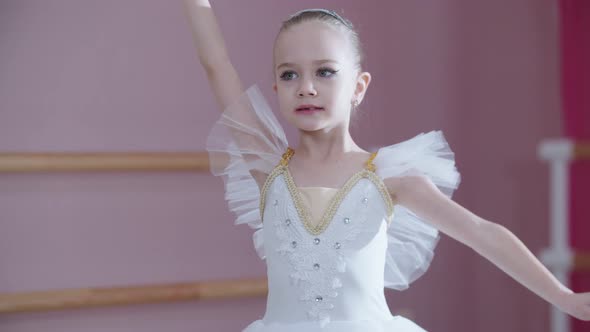 Ballet Training  a Little Girl in White Dress Spinning on the Spot