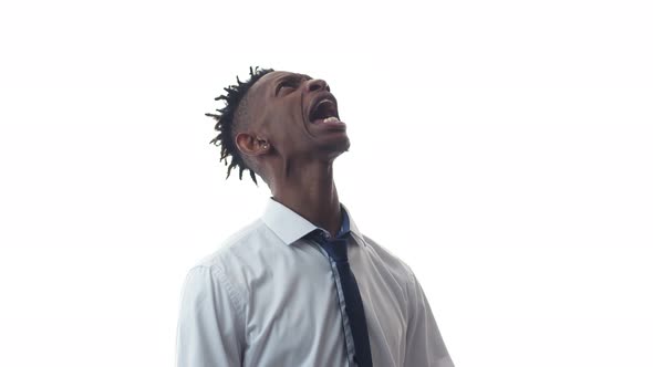 Black Office Worker a Man Screaming Upset While Looking Up in the Studio a White Background