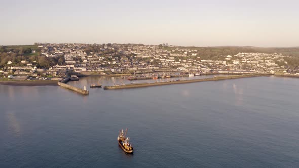 Fishing Boat Returning to Port at Sunrise