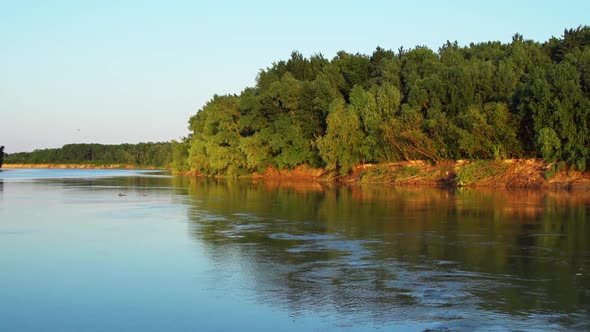 Panorama Of Siret River With Calm Waters And Lush Green Forest In The Background Near Galati In Roma