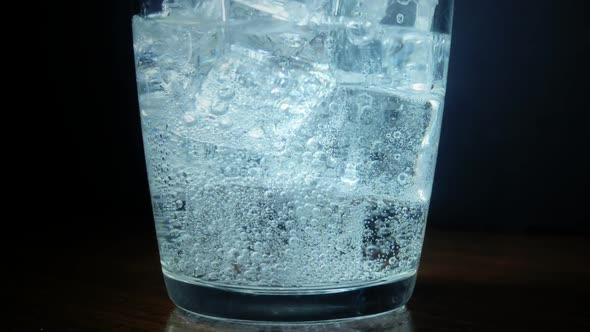 Pouring Soda Water with Ice Cubes