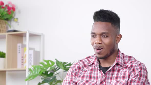 African man having online meeting in his working room at home