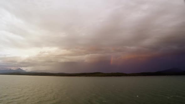 Time lapse of rainbow in clouds over the ocean from cruise ship