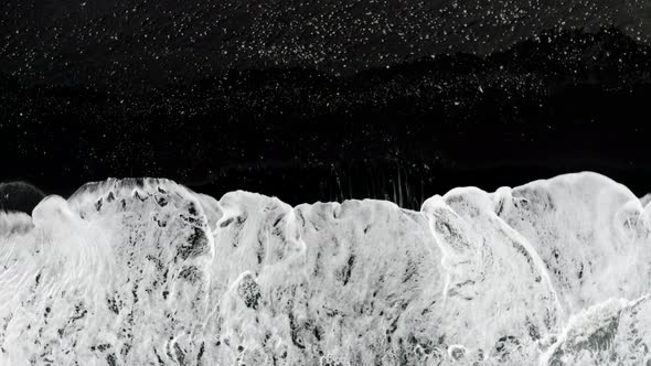 Foamy Waves Splashing On The Black-sand Beach Of Reynisfjara In Iceland