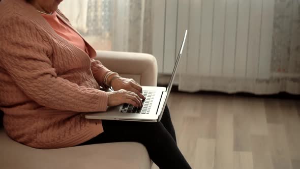 Senior Woman Using Laptop Computer.Elderly Woman Online Meeting With Grandchildren On Social Network