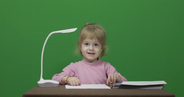 Girl Sitting at the Table. Education Process. Three Years Old Child. Chroma Key