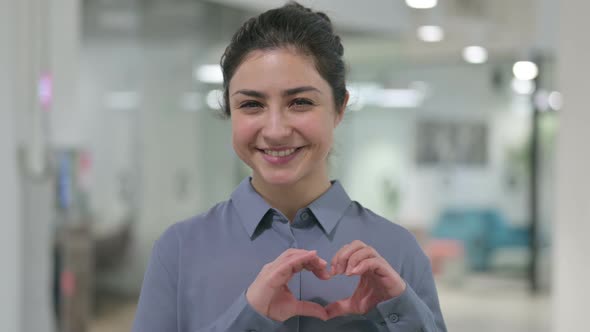 Portrait of Indian Woman Making Heart Shape By Hands