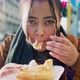 Portrait of young woman eating pastry outdoors, Italy - VideoHive Item for Sale