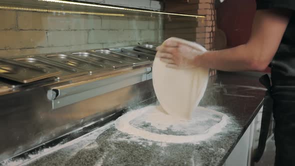 Close Up of Male Hands Kneading Dough Pizza