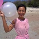 Romantic Birthday Surprise on the Ocean Coast Cheerful Woman in Pink Dress Holding Balloons True - VideoHive Item for Sale