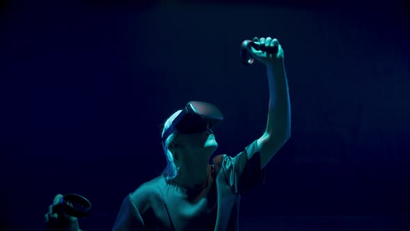 Man Playing Vr Headset Game in Neon Lights