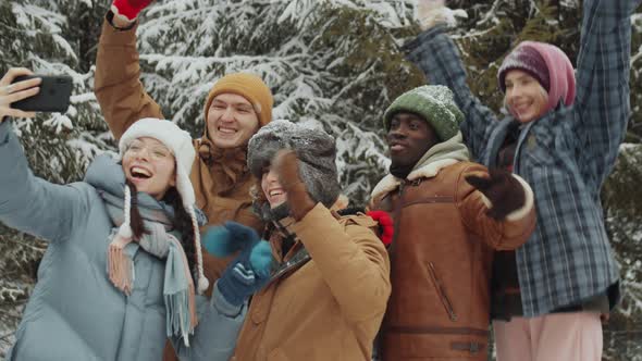 Happy Friends Taking Selfie in Winter Forest