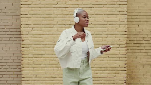 Slow motion shot of woman listening to music and dancing