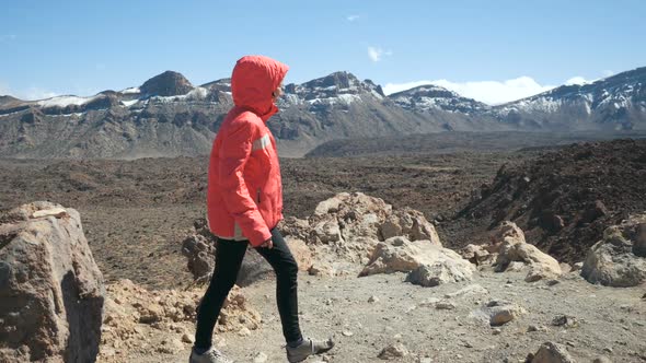 Young Woman Walking High in Mountains and Observing a Huge Crater of Teide Volcano in Tenerife