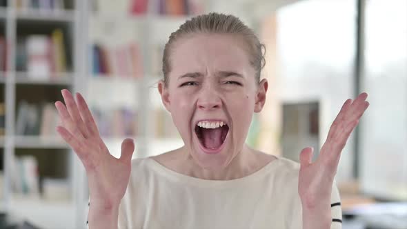 Portrait of Angry Young Woman Shouting Screaming