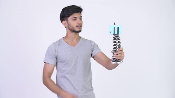 Young Happy Bearded Indian Man Vlogging with Phone