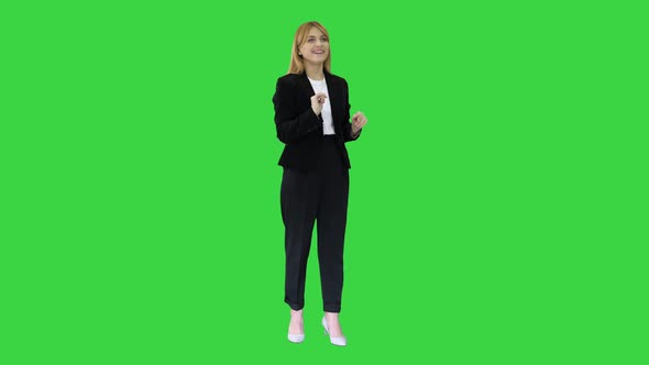 Happy Businesswoman Using Virtual Digital Screen in Front of Her on a Green Screen, Chroma Key.