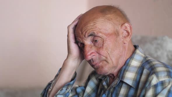 portrait of caucasian pensive pensioner 70-80 years old .sad elderly man depressed at home.sad wrink