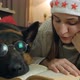 Young Woman and Dog in Glasses are Resting on the Bed at Home - VideoHive Item for Sale