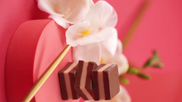 Vertical video, Close up: Composition of chocolate and candies on a red background