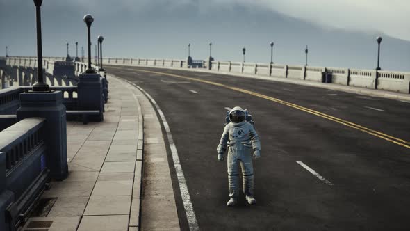 Astronaut in Space Suit on the Road Bridge alt