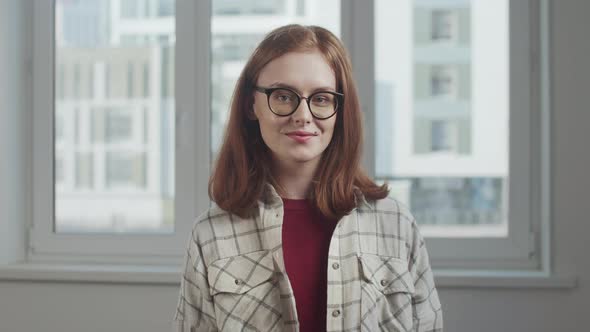 Nerd Girl in Glasses Happily Smiles and Poses