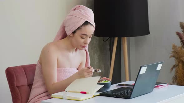 Business Lady with a Towel on Head Eating Healthy Breaksfast and Talking Online