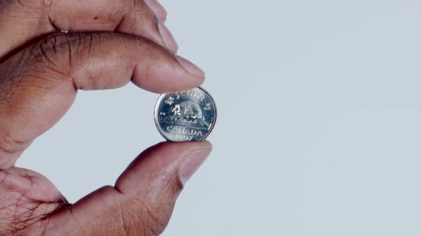 Hand Holding Canada 5 Cents Back