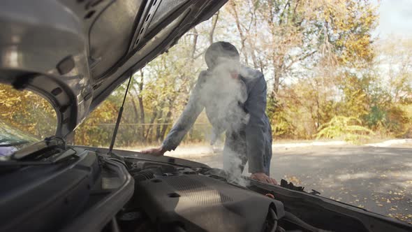 Man in Trying to Fix a Damaged Car