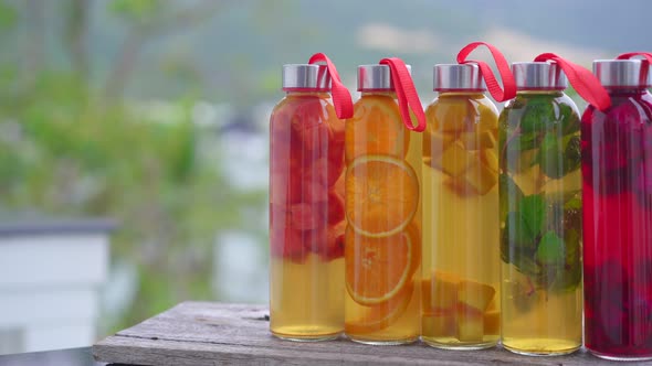 A Set of Colorful Glass Bottles with Different Flavors of Kombucha Drink Such As Watermelon Orange