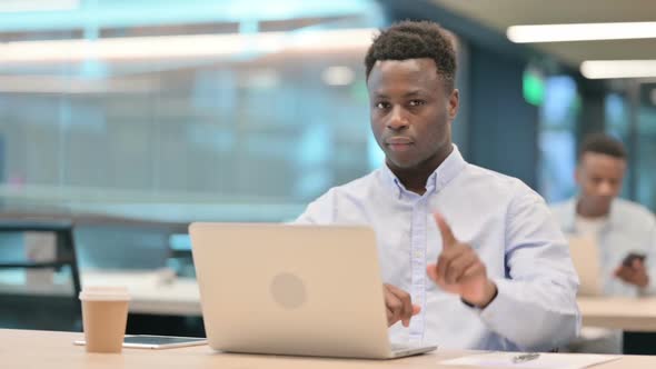 No Gesture with Head Shake By African Businessman at Work