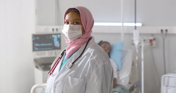 Portrait of Arabian Woman Doctor in Protective Mask Looking at Camera Working at Hospital