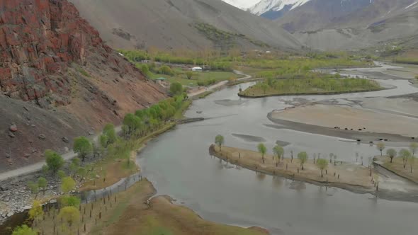 Aerial Over Riverbend Of Ghizer River With Valley Landscape In The Background In Pakistan