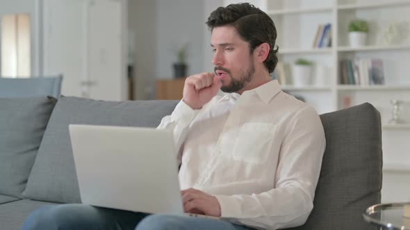 Sick Businessman Working on Laptop and Coughing at Home