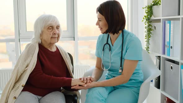 Therapist Talking to Senior Woman in Clinic