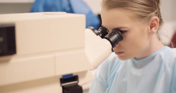 Scientist Examining Bacteria Under Microscope at Laboratory