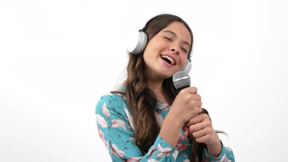 Vocal Training of Happy Kid Singer in Studio Headphones Singing in Microphone Music