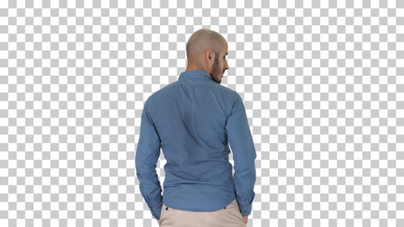 Arab in casual looking around with hands in pockets, Alpha Channel