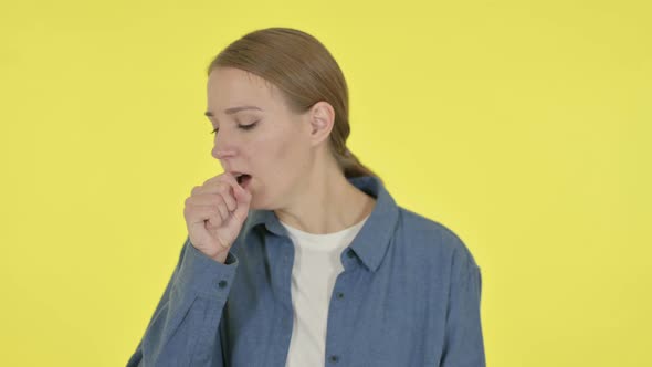 Young Woman Coughing on Yellow Background