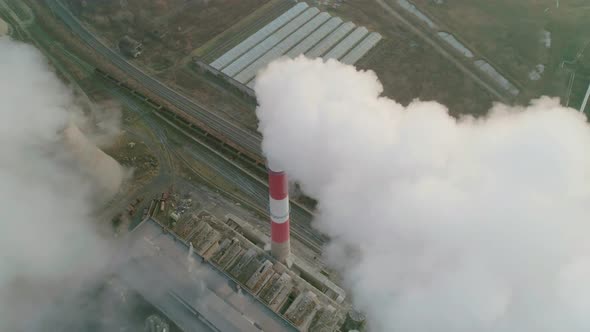 Aerial Drone View of Tall Chimney Pipes with Grey Smoke From Coal Power Plant